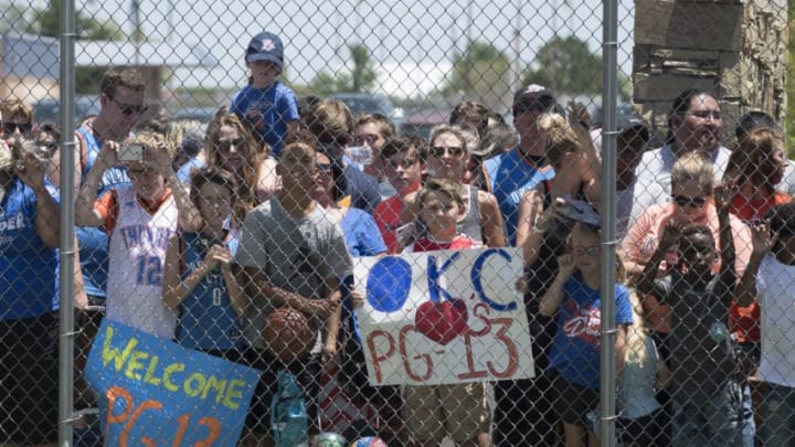 OKLAHOMA CITY, OK - JULY 11: Thunder fans greet Paul George of the Oklahoma City Thunder on July 11, 2017 at the Will Rogers Airport in Oklahoma City, Oklahoma. The Thunder acquired George from the Indiana Pacers in a trade. NOTE TO USER: User expressly acknowledges and agrees that, by downloading and or using this Photograph, user is consenting to the terms and conditions of the Getty Images License Agreement. Mandatory Copyright Notice: Copyright 2017 NBAE (Photo by Layne Murdoch/NBAE via Getty Images)