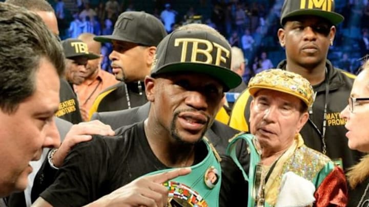 Sep 13, 2014; Las Vegas, NV, USA; Floyd Mayweather celebrates in the ring after defeating Marcos Maidana (not pictured) in their WBC & WBA Welterweight and WBC Superwelter Weight title fight at the MGM Grand Garden Arena. Mandatory Credit: Jayne Kamin-Oncea-USA TODAY Sports Sep 13, 2014; Las Vegas, NV, USA; Floyd Mayweather celebrates in the ring after defeating Marcos Maidana (not pictured) in their WBC & WBA Welterweight and WBC Superwelter Weight title fight at the MGM Grand Garden Arena. Mandatory Credit: Jayne Kamin-Oncea-USA TODAY Sports