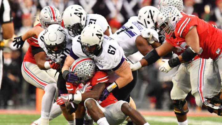 COLUMBUS, OH - OCTOBER 29: Tyler Lancaster #67 of the Northwestern Wildcats wraps up ballcarrier Curtis Samuel #4 of the Ohio State Buckeyes after a short gain in the third quarter at Ohio Stadium on October 29, 2016 in Columbus, Ohio. Ohio State defeated Northwestern 24-20. (Photo by Jamie Sabau/Getty Images)