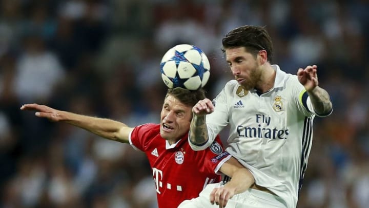 MADRID, SPAIN - APRIL 18: Thomas Muller of Bayern Muenchen wins the header before Sergio Ramos of Real Madrid CF during the UEFA Champions League Quarter Final second leg match between Real Madrid CF and FC Bayern Muenchen at Estadio Santiago Bernabeu on April 18, 2017 in Madrid, Spain. (Photo by Gonzalo Arroyo Moreno/Getty Images)