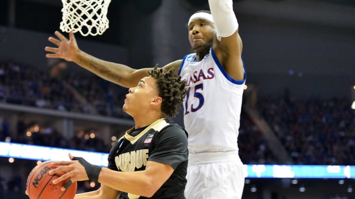 Mar 23, 2017; Kansas City, MO, USA; Purdue Boilermakers guard Carsen Edwards (3) looks to shoot as Kansas Jayhawks forward Carlton Bragg Jr. (15) defends during the first half in the semifinals of the midwest Regional of the 2017 NCAA Tournament at Sprint Center. Mandatory Credit: Denny Medley-USA TODAY Sports