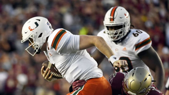 Nov 13, 2021; Tallahassee, Florida, USA; Miami Hurricanes quarterback Tyler Van Dyke (9) is tackled by Florida State Seminoles defensive end Jermaine Johnson II (11) during the game at Doak S. Campbell Stadium. Mandatory Credit: Melina Myers-USA TODAY Sports