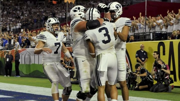 Sep 3, 2016; Glendale, AZ, USA; Brigham Young Cougars quarterback Taysom Hill (7) offensive lineman Parker Dawe (54) wide receiver Colby Pearson (3) and wide receiver Nick Kurtz (5) celebrate after scoring a touchdown against the Arizona Wildcats during the fourth quarter at University of Phoenix Stadium. The Cougars won 18-16. Mandatory Credit: Casey Sapio-USA TODAY Sports