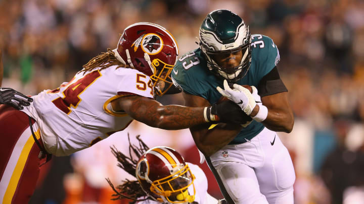 PHILADELPHIA, PA – DECEMBER 03: Running back Josh Adams #33 of the Philadelphia Eagles runs the ball and is tackled by linebacker Mason Foster #54 and safety D.J. Swearinger #36 of the Washington Redskins in the first quarter at Lincoln Financial Field on December 3, 2018 in Philadelphia, Pennsylvania. (Photo by Mitchell Leff/Getty Images)