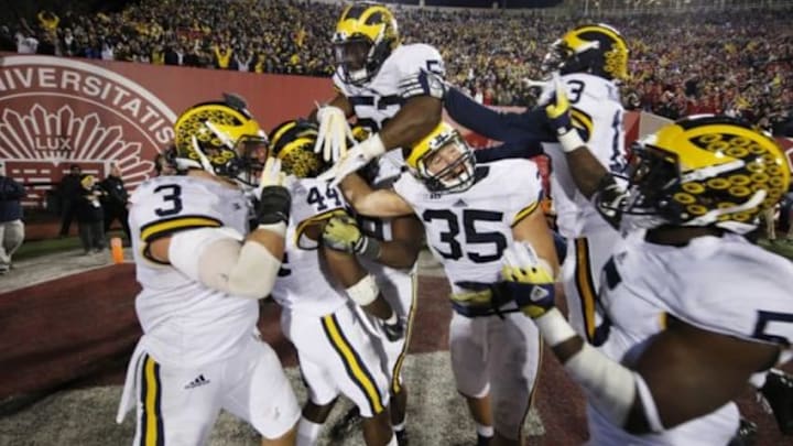 Nov 14, 2015; Bloomington, IN, USA; Michigan Wolverines safety Delano Hill (44) celebrates with teammates after making the last defensive play of the game to give Michigan the victory against the Indiana Hoosiers at Memorial Stadium. Michigan defeats Indiana in double overtime 48-41. Mandatory Credit: Brian Spurlock-USA TODAY Sports