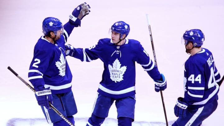 TORONTO - APRIL 23: From left, Toronto Maple Leafs defenseman Ron Hainsey, center Mitchell Marner and defenseman Morgan Rielly celebrate Marner's goal in the second period. The Toronto Maple Leafs host the Boston Bruins in Game 6 of the Eastern Conference First Round during the 2018 NHL Stanley Cup Playoffs at the Air Canada Centre in Toronto, Ontario on April 23, 2018. (Photo by Barry Chin/The Boston Globe via Getty Images)