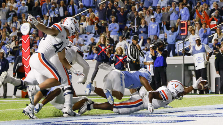 Oct 21, 2023; Chapel Hill, North Carolina, USA; Virginia Cavaliers running back Mike Hollins (7) fumbles the ball in the end zone against the North Carolina Tar Heels in the second half at Kenan Memorial Stadium. Mandatory Credit: Nell Redmond-USA TODAY Sports