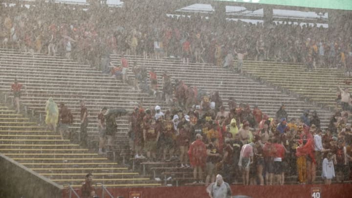 AMES, IA - SEPTEMBER 14: Iowa State Cyclones students run for cover from a thunderstorm with lighting at Jack Trice Stadium on September 14, 2019 in Ames, Iowa. The game was delayed between the Iowa Hawkeyes and the Iowa State Cyclones because of lighting strikes. (Photo by David Purdy/Getty Images)
