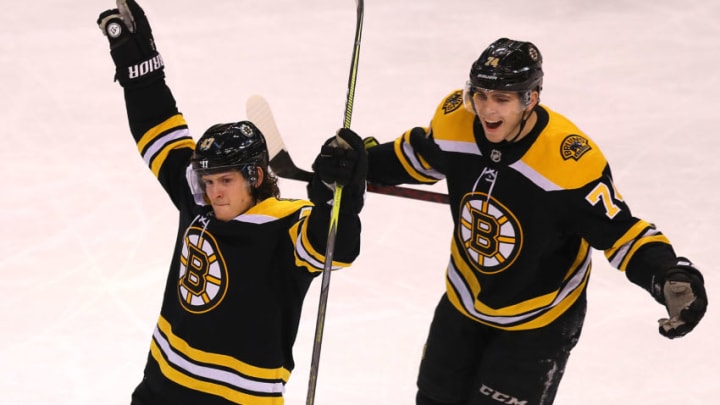 BOSTON - DECEMBER 21: Boston Bruins' Torey Krug, left, celebrates his third period goal with teammate Jake DeBrusk. The Boston Bruins host the Winnipeg Jets in a regular season NHL hockey game at TD Garden in Boston on Dec. 21, 2017. (Photo by John Tlumacki/The Boston Globe via Getty Images)