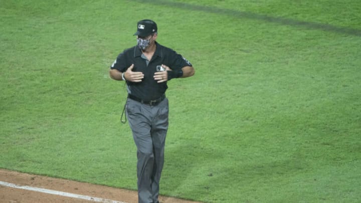 Aug 6, 2020; Philadelphia, Pennsylvania, USA; Umpire crew chief Angel Hernandez confirms that it was a crew chief review of the home run hit by New York Yankees catcher Gary Sanchez (24) to the Philadelphia Phillies bench during the seventh inning at Citizens Bank Park. Mandatory Credit: Gregory Fisher-USA TODAY Sports