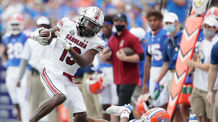 Oct 3, 2020; Gainesville, FL, USA; South Carolina receiver Shi Smith (13) spins out of a tackle by Florida Gators defensive back Jaydon hill (23) during a football game at Ben Hill Griffin Stadium. Mandatory Credit: Brad McClenny-USA TODAY NETWORK