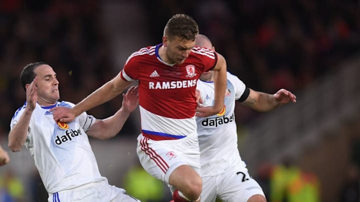 MIDDLESBROUGH, ENGLAND - APRIL 26: John O'Shea of Sunderland and Lee Cattermole of Sunderland (Obscured) tackle Ben Gibson of Middlesbrough during the Premier League match between Middlesbrough and Sunderland at the Riverside Stadium on April 26, 2017 in Middlesbrough, England. (Photo by Michael Regan/Getty Images)