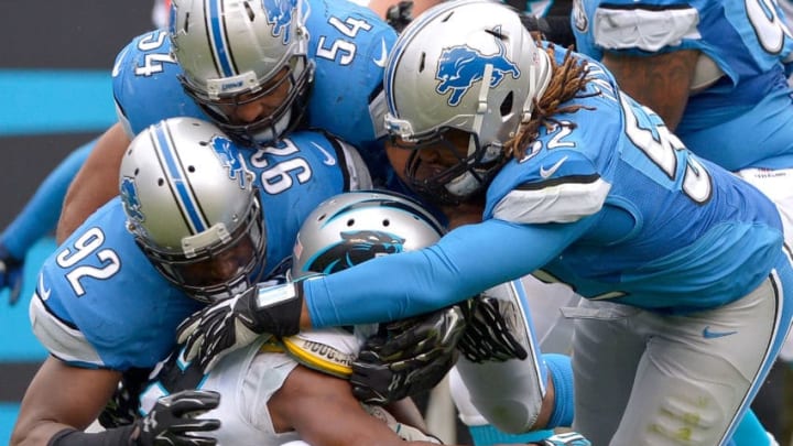 CHARLOTTE, NC - SEPTEMBER 14: Ezekiel Ansah #94, DeAndre Levy #54 and Darryl Tapp #52 of the Detroit Lions tackle Jonathan Stewart #28 of the Carolina Panthers during their game at Bank of America Stadium on September 14, 2014 in Charlotte, North Carolina. The Panthers won 24-7. (Photo by Grant Halverson/Getty Images)