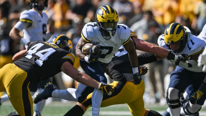 Oct 1, 2022; Iowa City, Iowa, USA; Michigan Wolverines running back Donovan Edwards (7) runs the ball as Iowa Hawkeyes linebacker Seth Benson (44) moves in for the tackle as offensive lineman Trevor Keegan (77) attempts to block during the first quarter at Kinnick Stadium. Mandatory Credit: Jeffrey Becker-USA TODAY Sports