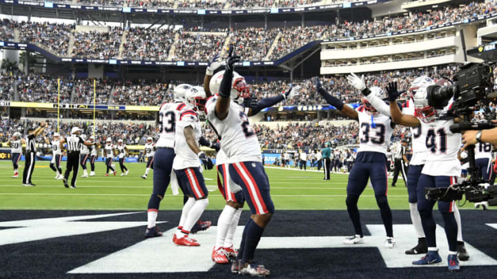 INGLEWOOD, CALIFORNIA - OCTOBER 31: Adrian Phillips #21 of the New England Patriots celebrates with teammates after returning an interception for a touchdown in the fourth quarter against the Los Angeles Chargers at SoFi Stadium on October 31, 2021 in Inglewood, California. (Photo by Kevork Djansezian/Getty Images)