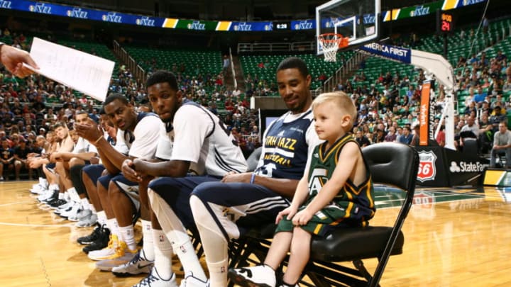 SALT LAKE CITY, UT - OCTOBER 06: JP Gibson, who was diagnosed with acute lymphoblastic leukemia, signed his contract with Jazz president Randy Rigby before joining the team in uniform for the annual preseason intrasquad scrimmage at EnergySolutions Arena on October 06, 2014 in Salt Lake City, Utah. Copyright 2014 NBAE (Photo by Melissa Majchrzak/NBAE via Getty Images)