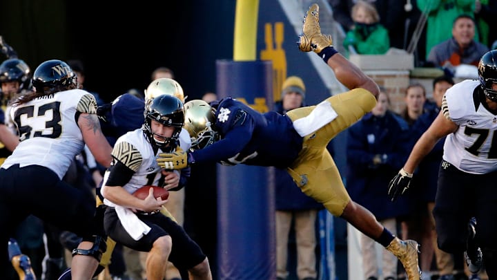 SOUTH BEND, IN – NOVEMBER 14: Romeo Okwara #45 of the Notre Dame Fighting Irish leaps through the air to sack John Wolford #10 of the Wake Forest Demon Deacons during the second quarter at Notre Dame Stadium on November 14, 2015, in South Bend, Indiana. (Photo by Jon Durr/Getty Images)