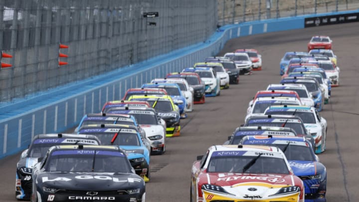 AVONDALE, ARIZONA - MARCH 11: Sammy Smith, driver of the #18 Pilot Flying J Toyota, and Kyle Busch, driver of the #10 LA Golf Chevrolet, lead the field during the NASCAR Xfinity Series United Rentals 200 at Phoenix Raceway on March 11, 2023 in Avondale, Arizona. (Photo by Chris Graythen/Getty Images)