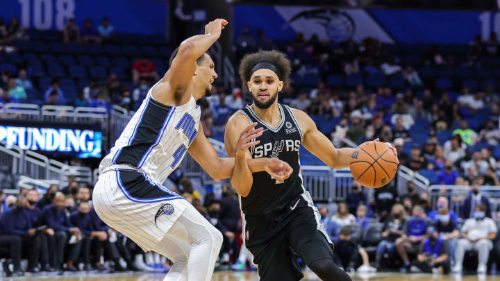 Oct 10, 2021; Orlando, Florida, USA; San Antonio Spurs guard Derrick White (4) drives to the basket against Orlando Magic guard Jalen Suggs (4) during the second half at Amway Center. Mandatory Credit: Mike Watters-USA TODAY Sports