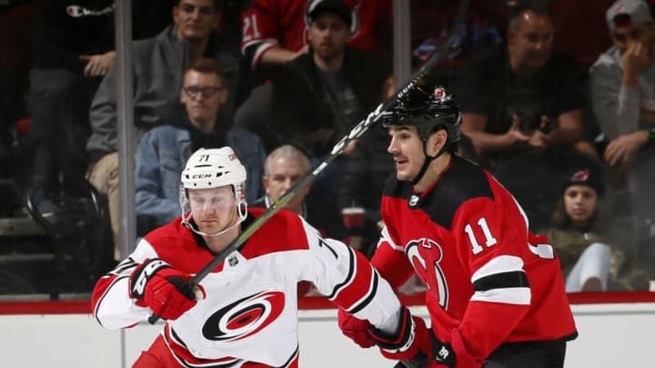 NEWARK, NJ - DECEMBER 29: Lucas Wallmark #71 of the Carolina Hurricanes skates around Brian Boyle #11 of the New Jersey Devils during an NHL hockey game on December 29, 2018 at the Prudential Center in Newark, New Jersey. Devils won 2-0. (Photo by Paul Bereswill/Getty Images)