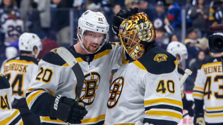 WINNIPEG, MB - JANUARY 31: Joakim Nordstrom #20 and goaltender Tuukka Rask #40 of the Boston Bruins celebrate a 2-1 victory over the Winnipeg Jets at the Bell MTS Place on January 31, 2020 in Winnipeg, Manitoba, Canada. (Photo by Jonathan Kozub/NHLI via Getty Images)