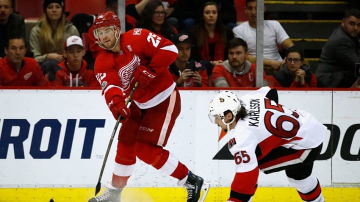 DETROIT, MI - APRIL 03: Mike Green #25 of the Detroit Red Wings passes the puck over the stick of Erik Karlsson #65 of the Ottawa Senators during the third period at Joe Louis Arena on April 3, 2017 in Detroit, Michigan. Detroit won the game 5-4 in a shootout. (Photo by Gregory Shamus/Getty Images)