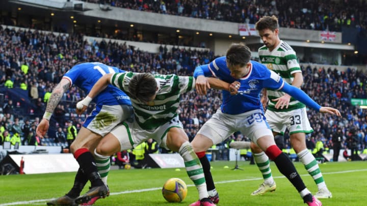 GLASGOW, SCOTLAND - FEBRUARY 26: Hyeongyu Oh of Celtic holds off Ryan Kent and Scott Wright of Rangers during the Viaplay League Cup Final between Rangers and Celtic at Hampden Park on February 26, 2023 in Glasgow, Scotland. (Photo by Mark Runnacles/Getty Images)