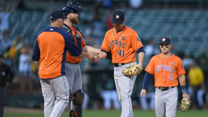 OAKLAND, CA - SEPTEMBER 09: Manager A.J. Hinch #14 of the Houston Astros takes the ball from starting pitcher Brad Peacock #41 taking him out of the game against the Oakland Athletics in the bottom of the six inning of the second game in a double header at Oakland Alameda Coliseum on September 9, 2017 in Oakland, California. (Photo by Thearon W. Henderson/Getty Images)