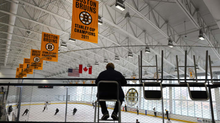 BOSTON - FEBRUARY 8: A lone fan sits in the stands with Stanley Cup banners hanging above as the Boston Bruins practice at Warrior Arena with new coach Bruce Cassidy on Feb. 8, 2017. (Photo by John Tlumacki/The Boston Globe via Getty Images)