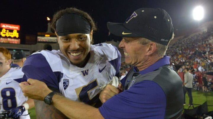 Oct 8, 2015; Los Angeles, CA, USA; Washington Huskies coach Chris Peterson (R) celebrates with defensive end Joe Mathis (5) after defeating the Southern California Trojans 17-12 at Los Angeles Memorial Coliseum. Mandatory Credit: Kirby Lee-USA TODAY Sports
