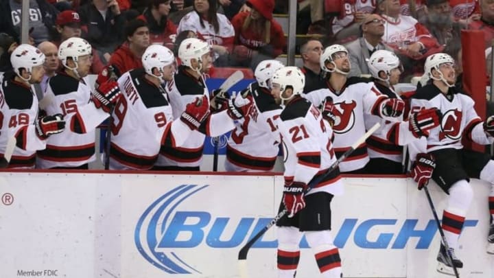 Dec 22, 2015; Detroit, MI, USA; New Jersey Devils right wing Kyle Palmieri (21) celebrates with his teammates after scoring a goal during the first period of the game against the Detroit Red Wings at Joe Louis Arena. The Devils defeated the Wings 4-3. Mandatory Credit: Leon Halip-USA TODAY Sports