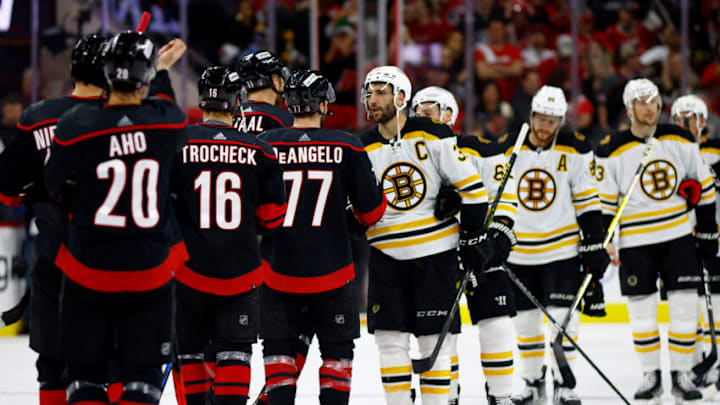 RALEIGH, NORTH CAROLINA - MAY 14: The Carolina Hurricanes shake hands with the Boston Bruins following Game Seven of the First Round of the 2022 Stanley Cup Playoffs at PNC Arena on May 14, 2022 in Raleigh, North Carolina. (Photo by Jared C. Tilton/Getty Images)