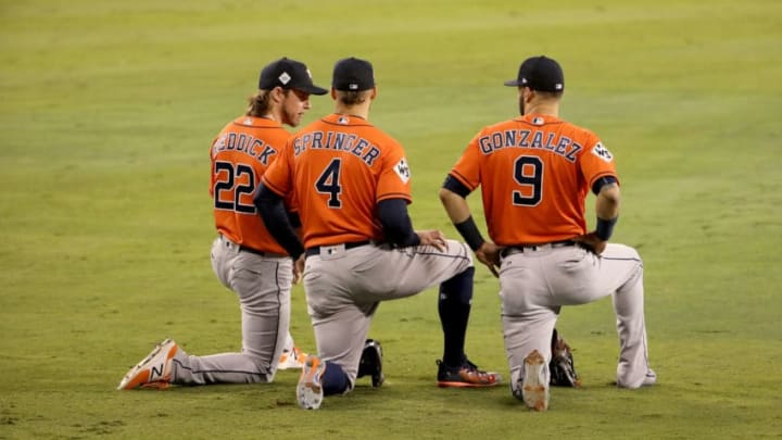 LOS ANGELES, CA - NOVEMBER 01: Josh Reddick #22, George Springer #4 and Marwin Gonzalez #9 of the Houston Astros kneel in the outfield during the fifth inning against the Los Angeles Dodgers in game seven of the 2017 World Series at Dodger Stadium on November 1, 2017 in Los Angeles, California. (Photo by Christian Petersen/Getty Images)
