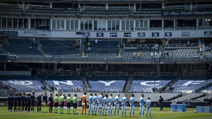 NEW YORK, NY - APRIL 24: Members of New York City FC and FC Cincinnati stand for a moment of silence for those that have been lost to the Corona Virus before the start of the home opener match at Yankee Stadium on April 24, 2021 in New York City. (Photo by Ira L. Black - Corbis/Getty Images)