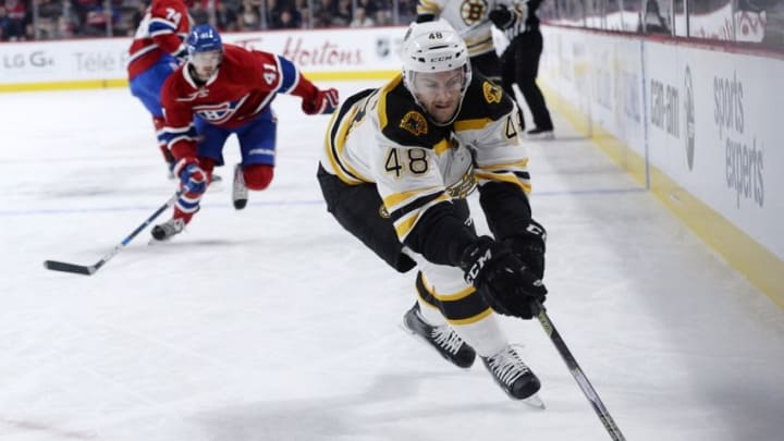 Nov 7, 2015; Montreal, Quebec, CAN; Boston Bruins defenseman Colin Miller (48) skates with the puck in front of Montreal Canadiens forward Paul Byron (41) during the first period at the Bell Centre. Mandatory Credit: Eric Bolte-USA TODAY Sports