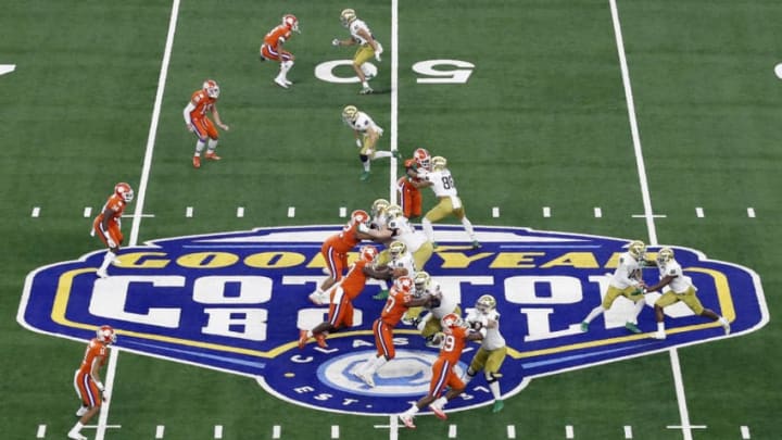 ARLINGTON, TEXAS - DECEMBER 29: Ian Book #12 of the Notre Dame Fighting Irish looks to hand off the ball in the first half against the Clemson Tigers during the College Football Playoff Semifinal Goodyear Cotton Bowl Classic at AT&T Stadium on December 29, 2018 in Arlington, Texas. (Photo by Tim Warner/Getty Images)