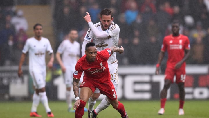 SWANSEA, WALES – MAY 01: Nathaniel Clyne of Liverpool is challenged by Gylfi Sigurdsson of Swansea City during the Barclays Premier League match between Swansea City and Liverpool at The Liberty Stadium on May 1, 2016 in Swansea, Wales. (Photo by Stu Forster/Getty Images)