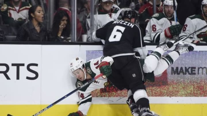 Oct 16, 2015; Los Angeles, CA, USA; Minnesota Wild left wing Jason Zucker (back) is knocked down by Los Angeles Kings center Jake Muzzin (6) during the second period at Staples Center. Mandatory Credit: Kelvin Kuo-USA TODAY Sports