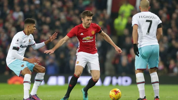 MANCHESTER, ENGLAND - NOVEMBER 30: Michael Carrick of Manchester United in action with Sofiane Feghouli of West Ham United during the EFL Cup Quarter-Final match between Manchester United and West Ham United at Old Trafford on November 30, 2016 in Manchester, England. (Photo by Tom Purslow/Man Utd via Getty Images)