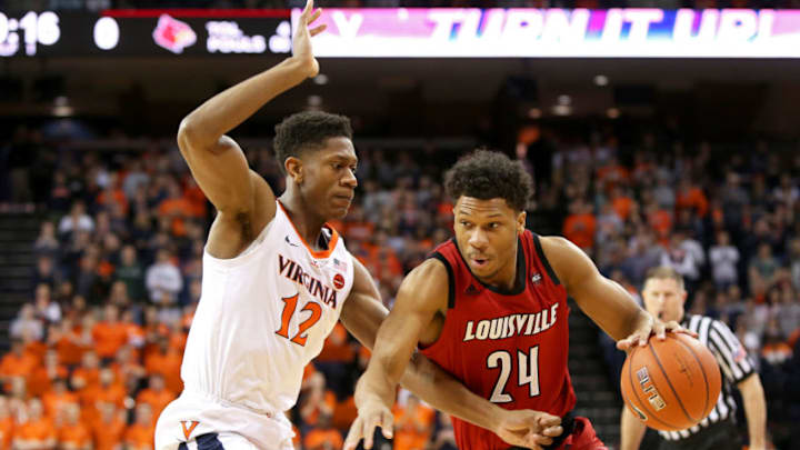 CHARLOTTESVILLE, VA - MARCH 09: Dwayne Sutton #24 of the Louisville Cardinals drives past De'Andre Hunter #12 of the Virginia Cavaliers in the first half during a game at John Paul Jones Arena on March 9, 2019 in Charlottesville, Virginia. (Photo by Ryan M. Kelly/Getty Images)