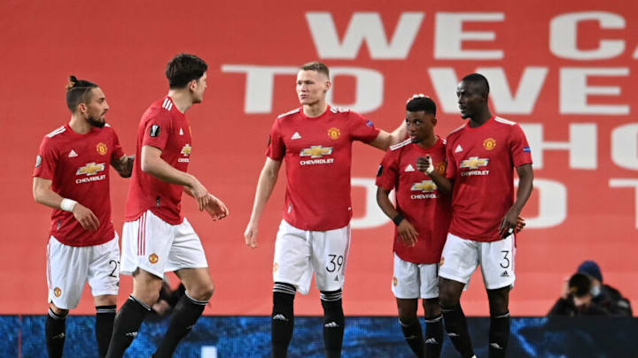 MANCHESTER, ENGLAND - MARCH 11: Amad Diallo of Manchester United celebrates with teammates Alex Telles, Harry Maguire, Scott McTominay and Eric Bailly after scoring their team's first goal during the UEFA Europa League Round of 16 First Leg match between Manchester United and A.C. Milan at Old Trafford on March 11, 2021 in Manchester, England. Sporting stadiums around the UK remain under strict restrictions due to the Coronavirus Pandemic as Government social distancing laws prohibit fans inside venues resulting in games being played behind closed doors. (Photo by Laurence Griffiths/Getty Images)