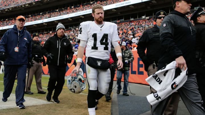 Jan 1, 2017; Denver, CO, USA; Oakland Raiders quarterback Matt McGloin (14) leaves the field in the second quarter against the Denver Broncos at Sports Authority Field at Mile High. Mandatory Credit: Isaiah J. Downing-USA TODAY Sports