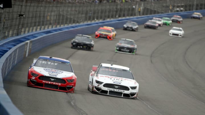 FONTANA, CALIFORNIA - MARCH 01: Joey Logano, driver of the #22 AAA Southern California Ford, and Brad Keselowski, driver of the #2 Discount Tire/Americas Tire Ford, lead a pack of cars during the NASCAR Cup Series Auto Club 400 at Auto Club Speedway on March 01, 2020 in Fontana, California. (Photo by Katelyn Mulcahy/Getty Images)
