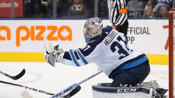 TORONTO, ON - OCTOBER 27: Winnipeg Jets Goalie Connor Hellebuyck (37) catches a puck shot on net during the regular season NHL game between the Winnipeg Jets and the Toronto Maple Leafs on October 27, 2018 at Scotiabank Arena in Toronto, ON. (Photo by Jeff Chevrier/Icon Sportswire via Getty Images)