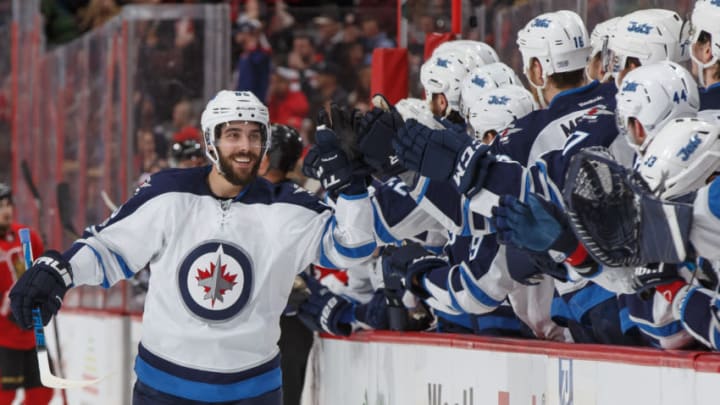 OTTAWA, ON - FEBRUARY 19: Mathieu Perreault #85 of the Winnipeg Jets smiles as he celebrates his first period goal against the Winnipeg Jets with teammates at the players bench at Canadian Tire Centre on February 19, 2017 in Ottawa, Ontario, Canada. (Photo by Andre Ringuette/NHLI via Getty Images)