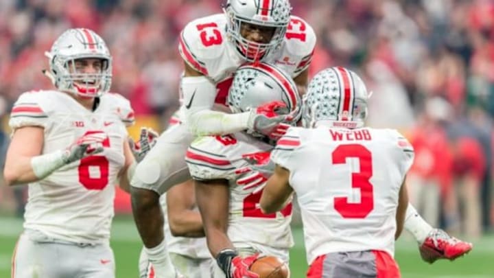 Jan 1, 2016; Glendale, AZ, USA; Ohio State Buckeyes cornerback Eli Apple (13) celebrates with safety Tyvis Powell (23) after an interception in the third quarter against the Notre Dame Fighting Irish in the 2016 Fiesta Bowl at University of Phoenix Stadium. Ohio State won 44-28. Mandatory Credit: Matt Cashore-USA TODAY Sports