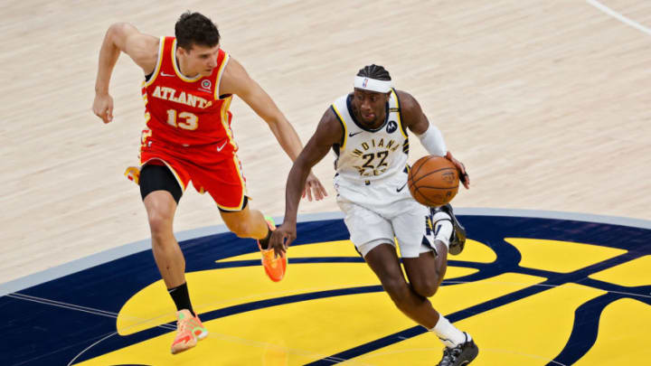 INDIANAPOLIS, INDIANA - MAY 06: Caris LeVert #22 of the Indiana Pacers dribbles the ball while being guarded by Bogdan Bogdanovic #13 of the Atlanta Hawks in the first quarter at Bankers Life Fieldhouse on May 06, 2021 in Indianapolis, Indiana. NOTE TO USER: User expressly acknowledges and agrees that, by downloading and or using this photograph, User is consenting to the terms and conditions of the Getty Images License Agreement. (Photo by Dylan Buell/Getty Images)