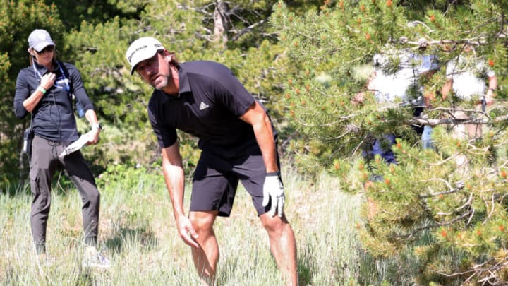 BIG SKY, MONTANA - JULY 06: Aaron Rodgers lines up a shot from the rough during Capital One's The Match at The Reserve at Moonlight Basin on July 06, 2021 in Big Sky, Montana. (Photo by Stacy Revere/Getty Images for The Match)