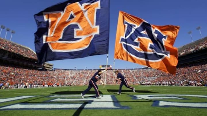 Nov 3, 2012; Auburn, AL, USA: Auburn Tigers cheerleaders carry Auburn flags after the Tigers scored a touchdown against the New Mexico State Aggies at Jordan-Hare Stadium. The Tigers beat the Aggies 42-7. Mandatory Credit: John Reed-USA TODAY Sports