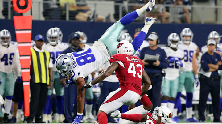 ARLINGTON, TX - AUGUST 26: Rico Gathers #80 of the Dallas Cowboys dives past Haason Reddick #43 of the Arizona Cardinals for a first down in the first quarter of a preseason football game at AT&T Stadium on August 26, 2018 in Arlington, Texas. (Photo by Richard Rodriguez/Getty Images)